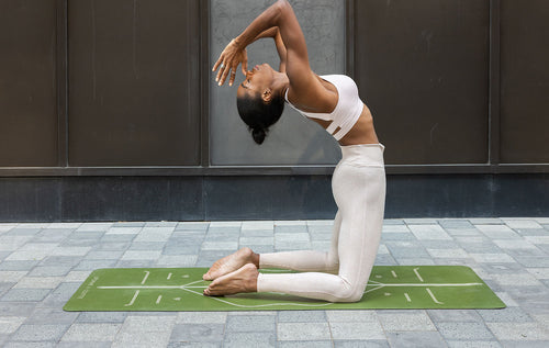 Camel Pose on a Green Liforme Yoga mat to open the Throat Chakra