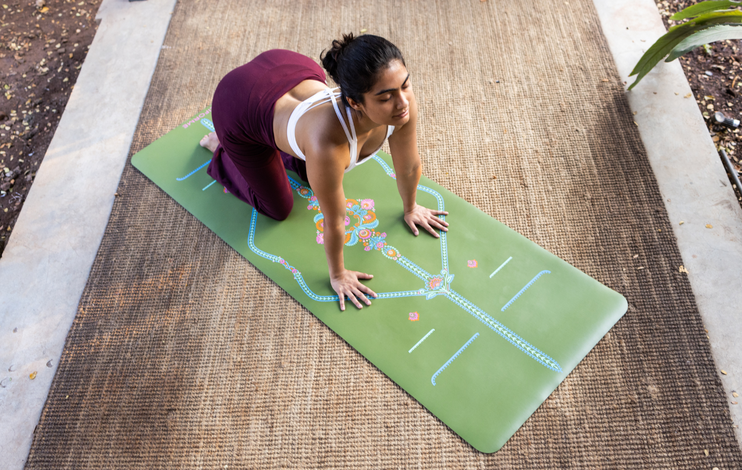 Woman doing Cow yoga pose on a green Liforme Yoga mat