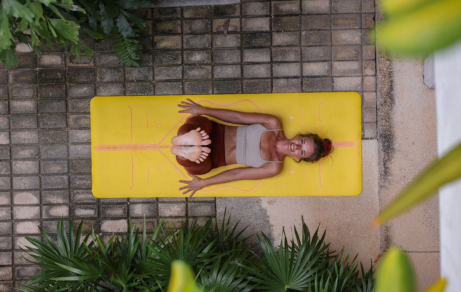 Legs up the wall waterfall on a yellow Liforme yoga mat