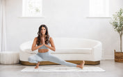 Hannah Barrett does skandasana on a white Liforme yoga mat
