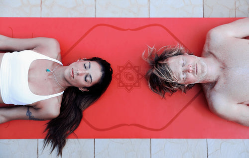 Couple on a red Liforme Yoga mat with hearts