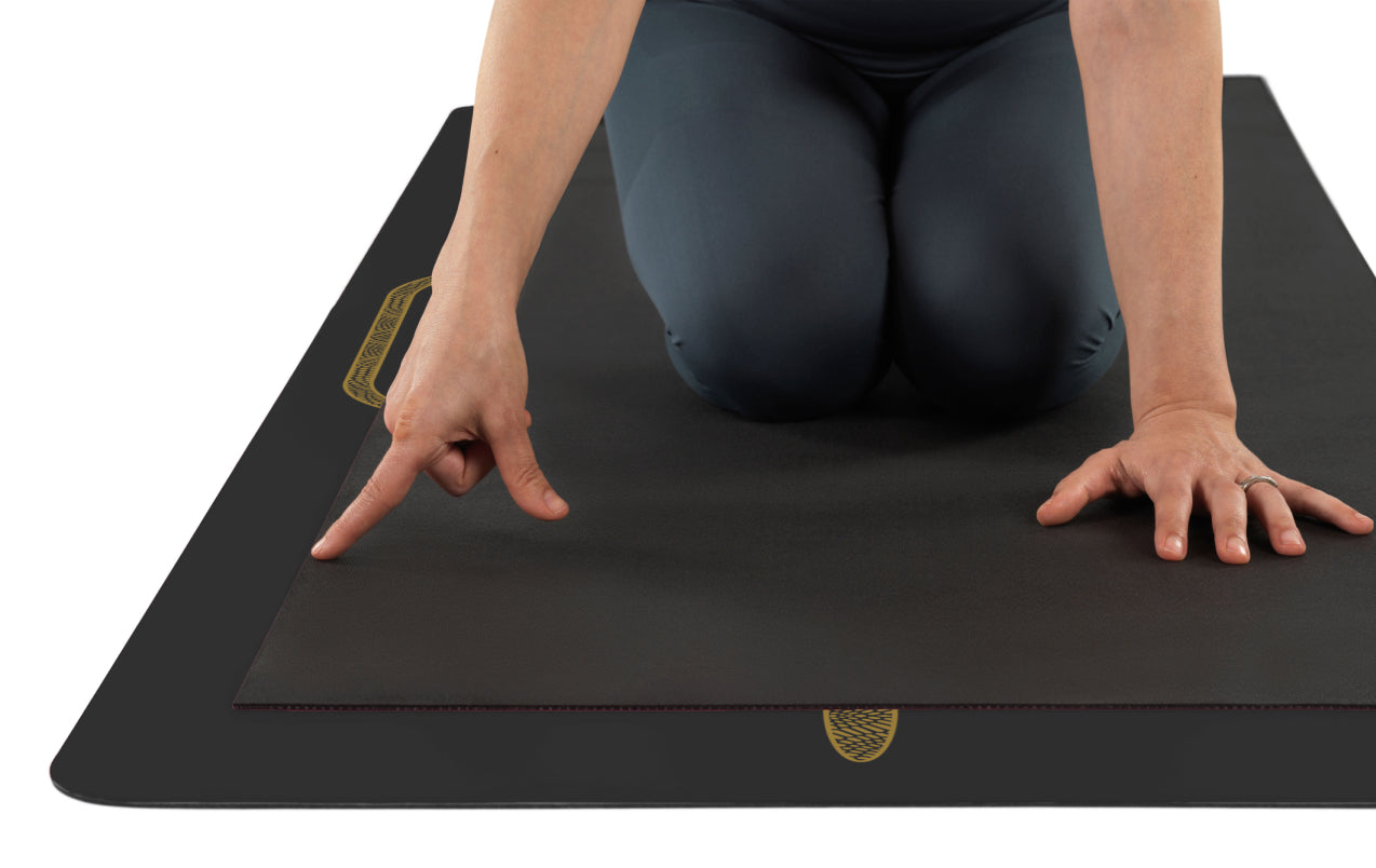 Overhead view of the Liforme Black & Gold Yoga Mat illustrating its extra-large dimensions, providing more space than standard mats for various yoga poses.