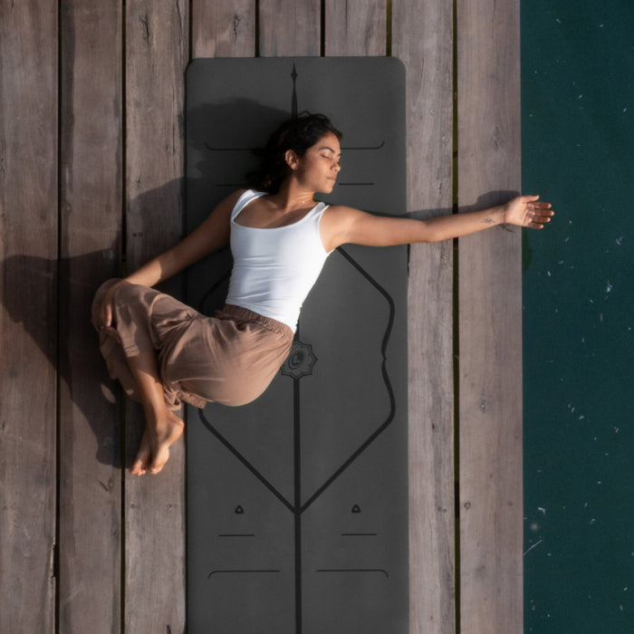 Yogi laying on a Grey Liforme Classic Yoga Mat