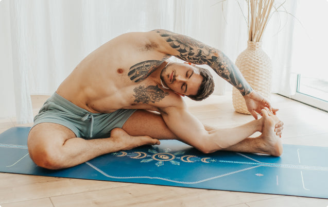 Man on the Liforme Cosmic Yoga Mat, showing the moisture-wicking texture that provides a hygienic, slip-free practice.
