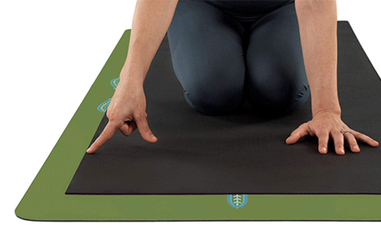 Top-down view showing the extra-large dimensions of the Forest Green Liforme Yoga Mat, which is longer and wider than standard mats for more practice space.