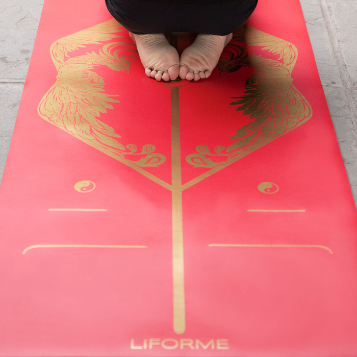 A man practicing yoga on a Liforme Phoenix Yoga Mat 
