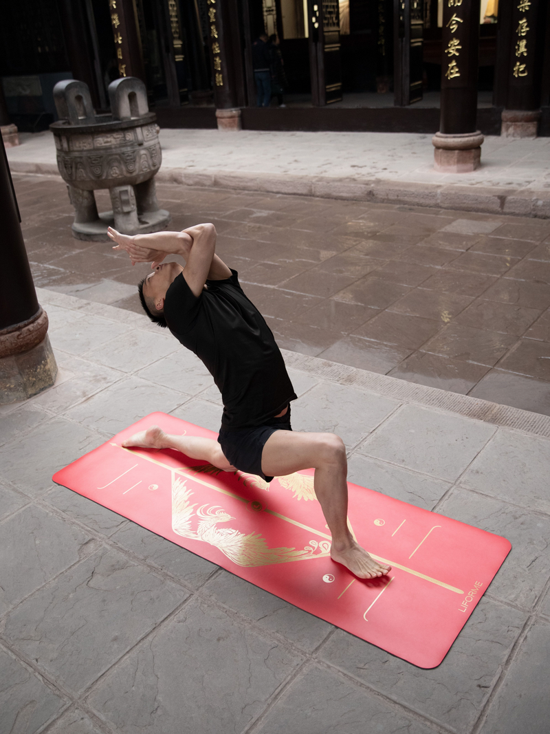 A man performing a Low Lunge Pose Eagle Arms yoga pose on a Liforme Phoenix Yoga Mat 