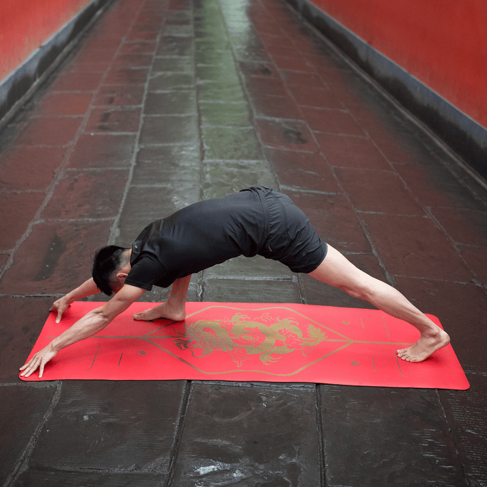 A man practicing  yoga on a Liforme Dragon Yoga Mat 
