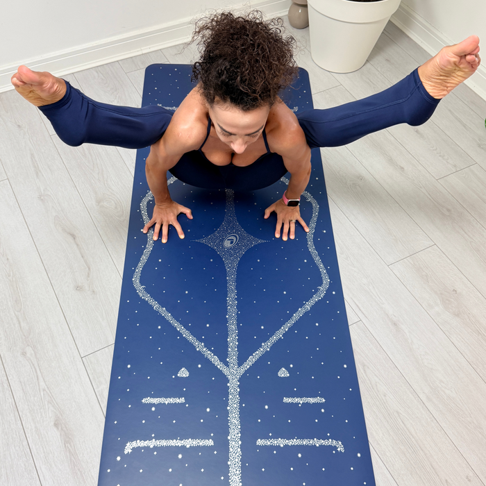 A woman in a yoga pose on a Liforme Magic Galaxy Yoga Mat Silver Dusk Blue 