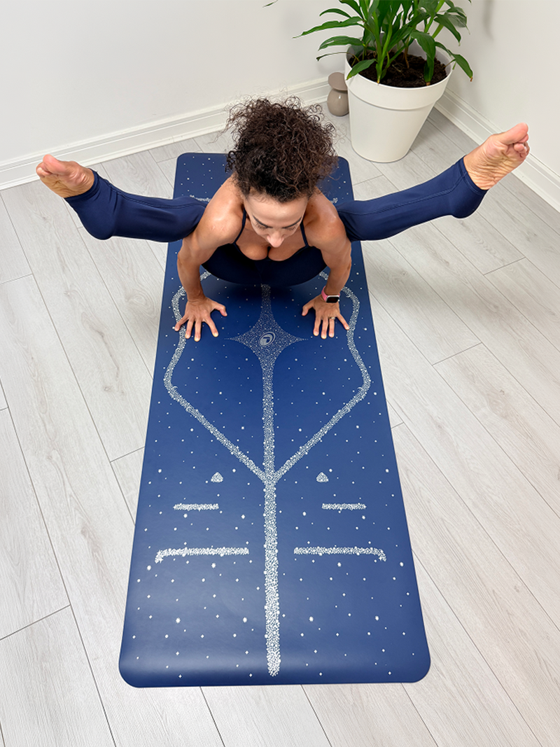 A woman in a yoga pose on a Liforme Magic Galaxy Yoga Mat Silver Dusk Blue 
