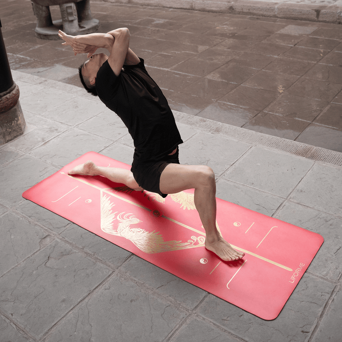 A man performing a Low Lunge Pose Eagle Arms yoga pose on a Liforme Phoenix Yoga Mat 
