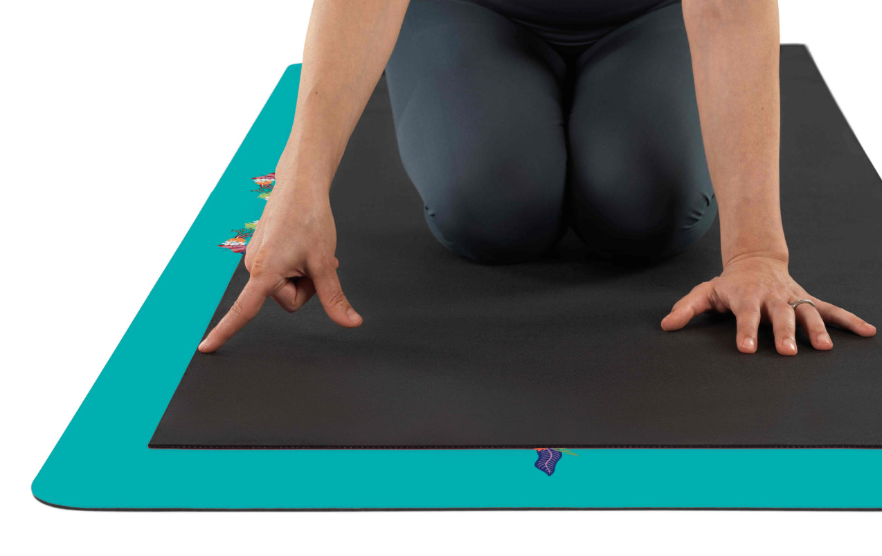Top-down view showing the extra-large dimensions of the Liforme Tropical Paradise Aqua teal Yoga Mat, which is longer and wider than standard mats for more practice space.