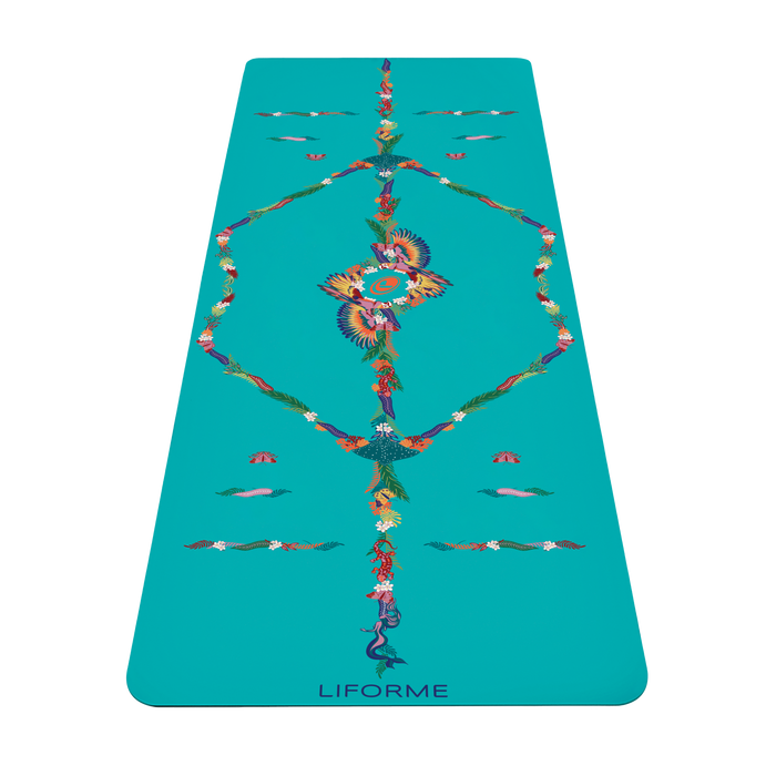Una vista de arriba hacia abajo del color turquesa. Liforme Tropical Paradise Esterilla de yoga con un sistema de alineación decorado con intrincadas ilustraciones multicolores de pájaros, flores y enredaderas tropicales.