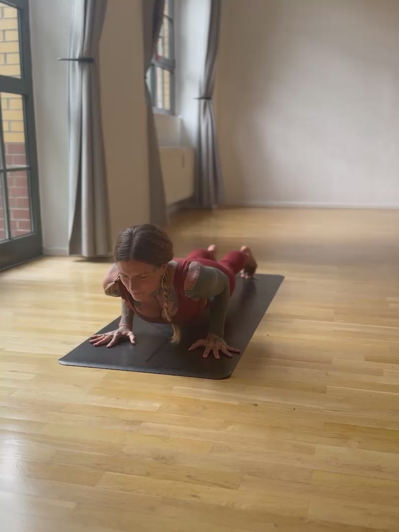 A person practicing yoga on a Liforme x Jivamukti Travel Yoga Mat
