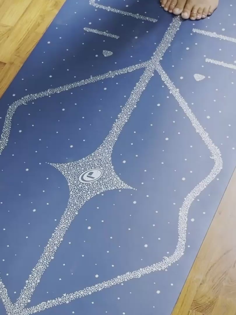 A woman practicing yoga on a Liforme Magic Galaxy Yoga Mat Silver Dusk Blue 