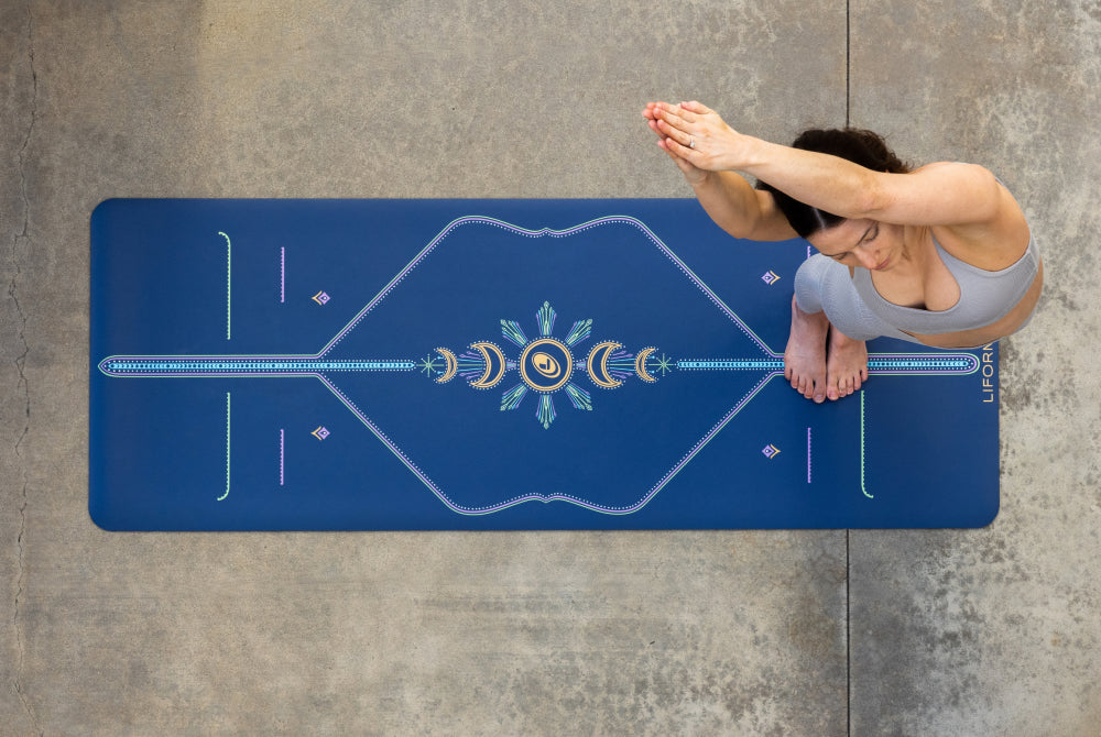 A Yogi using a Liforme Cosmic Moon Yoga Mat - Dusk Blue