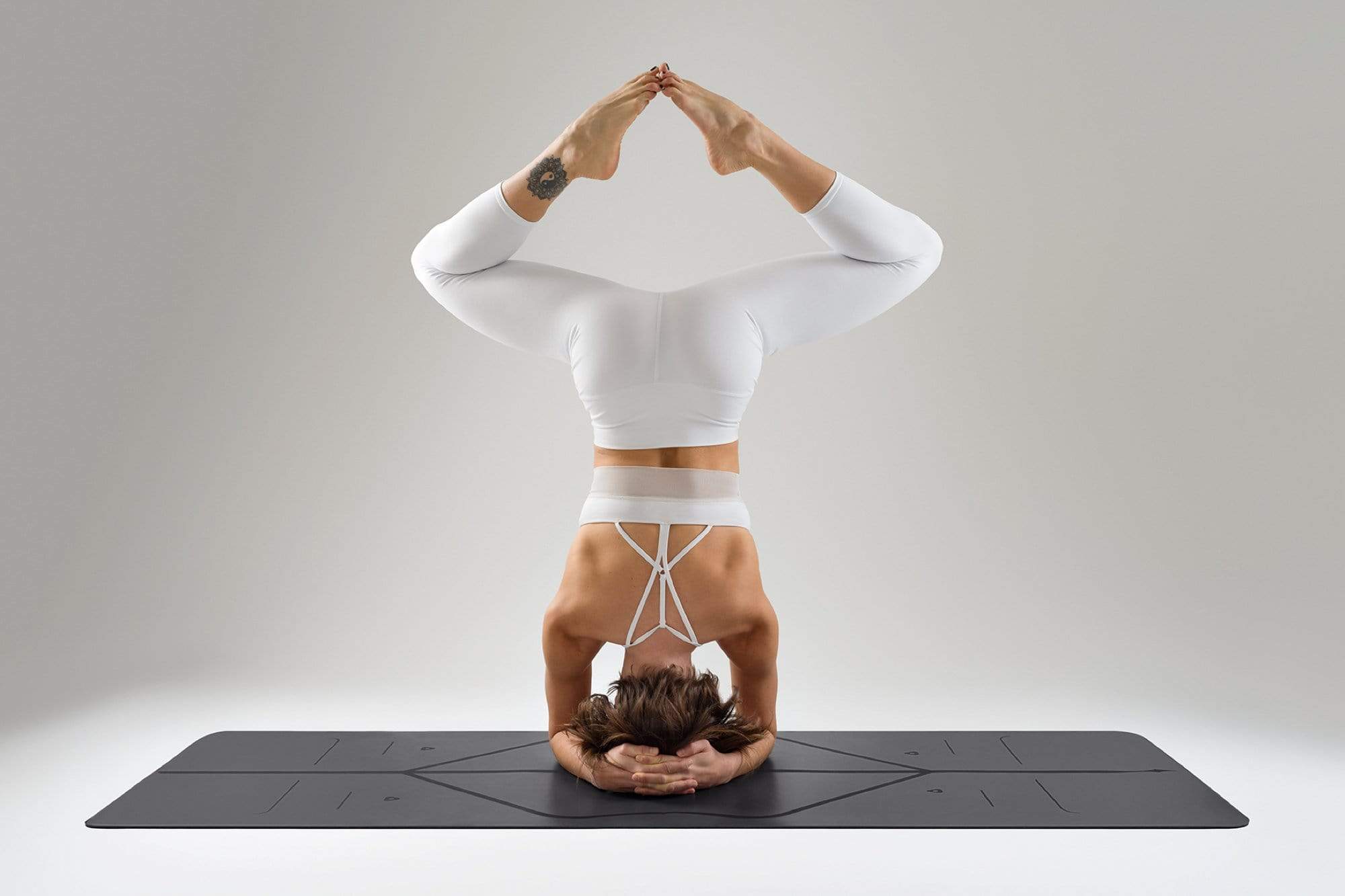 A Yogi on a grey Liforme Yoga Mat